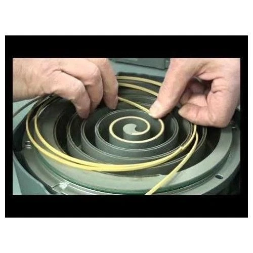Edwards Pump Parts & Accessories, hands fitting a yellow tip seal into a spiral scroll, close-up