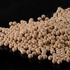 3A Molecular Sieve Beads 10 kg, scattered tan round beads on a black surface