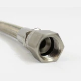 84" x 1/4" JIC PTFE Stainless Braided Hose, close-up of braided hose end with hex nut fitting