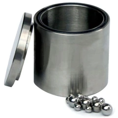 Stainless Steel 304 Grinding Jar with Lid, brushed steel jar with lid leaning beside it and grinding balls
