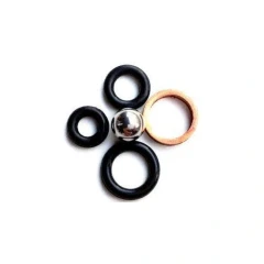 Pellet Press Sealing Gasket Set, black O-rings, a copper washer and a steel ball, white background
