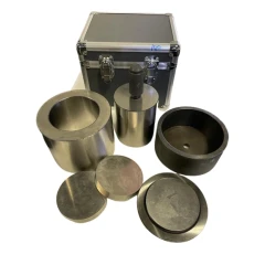 Ai 100mm Dry Pressing Die Set, steel sleeve, plunger with handle, discs and black ring in front of a case