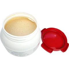 SonoMechanics NanoStabilizer-LT, open white tub of beige paste with red lid beside it