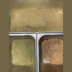 Separatore Tribostatico Trichome Separator, trays of separated green and brown plant powder, no machine shown