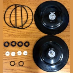 ULVAC UDP6 Diaphragm Pump Rebuild Kit, two black diaphragms, large O-rings, valves and seals on a wood table