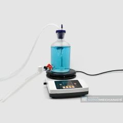 SonoMechanics 2L Stirring and Mixing Set, glass bottle of blue liquid on a stir plate with tubing and valve