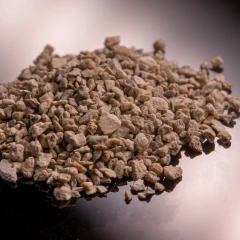 ZeoClear L granular attapulgite, heap of brown granules on a dark background