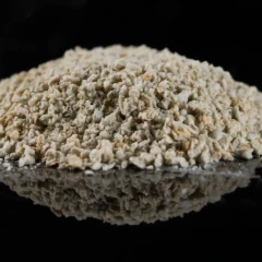 ZeoClear Y granular attapulgite, heap of light tan granules on a dark background
