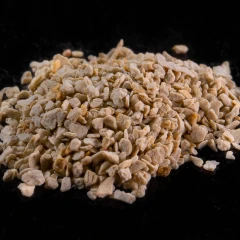 ZeoClear Y granular attapulgite, heap of light tan granules on a dark background – view 2