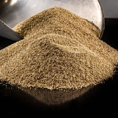 ZeoClear Y granular attapulgite, heap of light tan granules on a dark background – view 3
