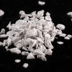 Activated Alumina granules, heap of white granules on a dark background – view 2