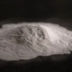 Silica 60A, heap of fine white powder on a dark background – view 2