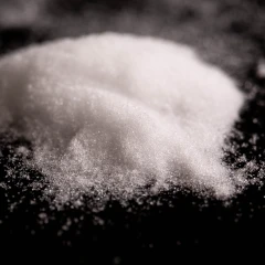 Silica 60A, heap of fine white powder on a dark background – view 3